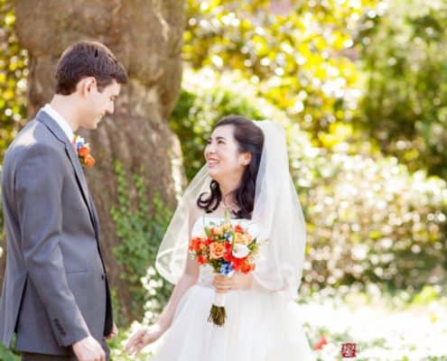 Bride and groom smile at each other during outdoor portraits at Princeton Cap and Gown Club wedding photographed by Kyo Morishima