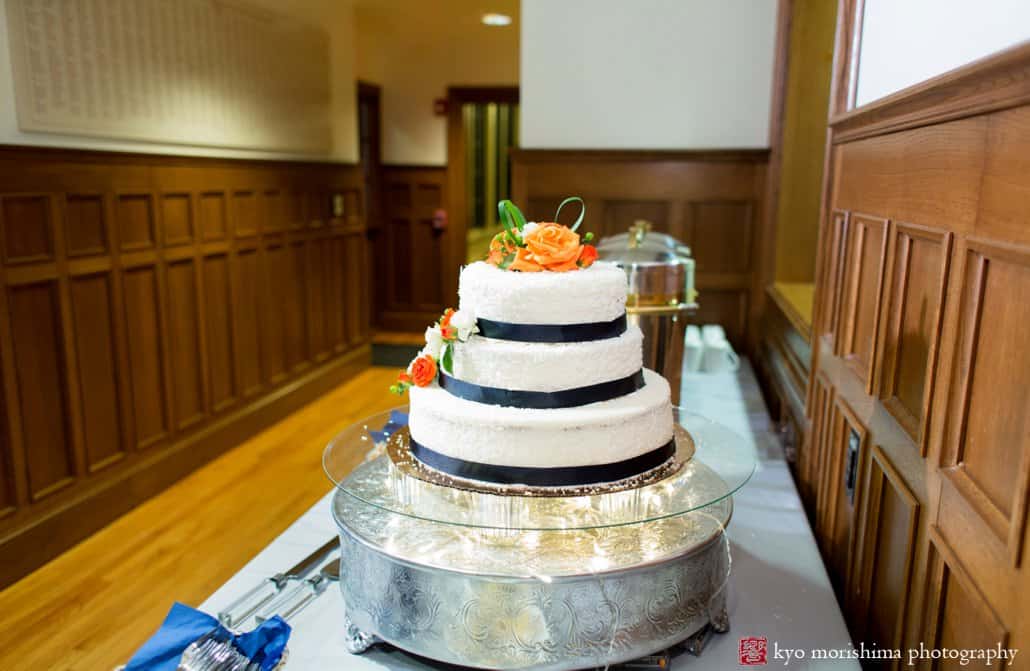 Whole Foods wedding cake decorated with royal blue ribbon and orange flowers at Cap and Gown Club of Princeton wedding photographed by Kyo Morishima