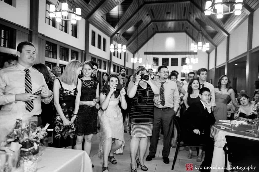 Guests watch bride and groom cut the cake in Princeton Cap and Gown Club eating hall, photographed by Kyo Morishima