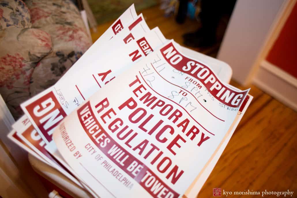 A stack of "Temporary Police Regulation" posters before block party wedding in Philadelphia begins, photographed by Kyo Morishima