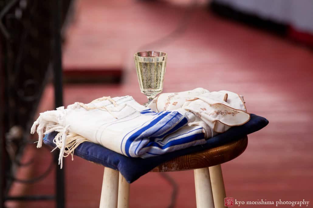 The kiddush cup and tallit on a stool before Philadelphia block party wedding begins, photographed by Kyo Morishima