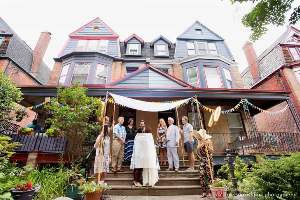 Bride and partner wear the tallit as Jewish wedding ceremony ends in West Philadelphia, photographed by Kyo Morishima