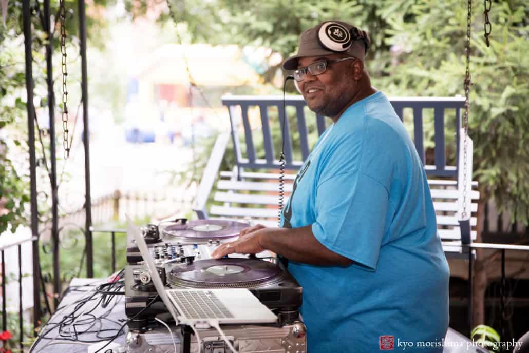 DJ smiles for the camera during West Philadelphia block party wedding, photographed by Kyo Morishima