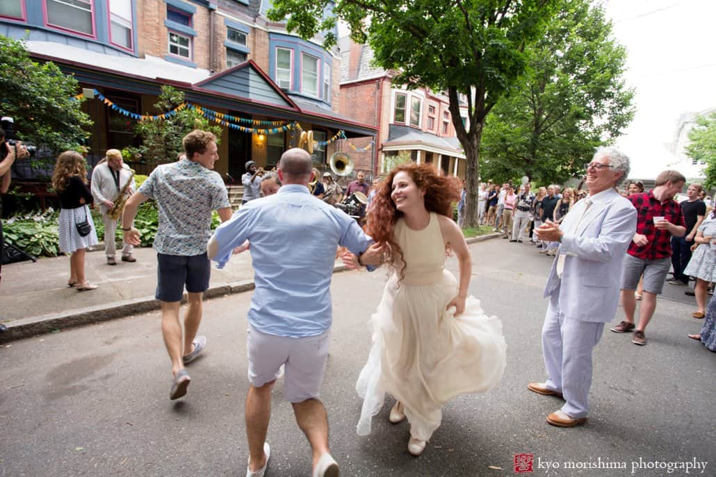 Bride dances with wedding guests to music by West Philly Orchestra during block party wedding photographed by Kyo Morishima