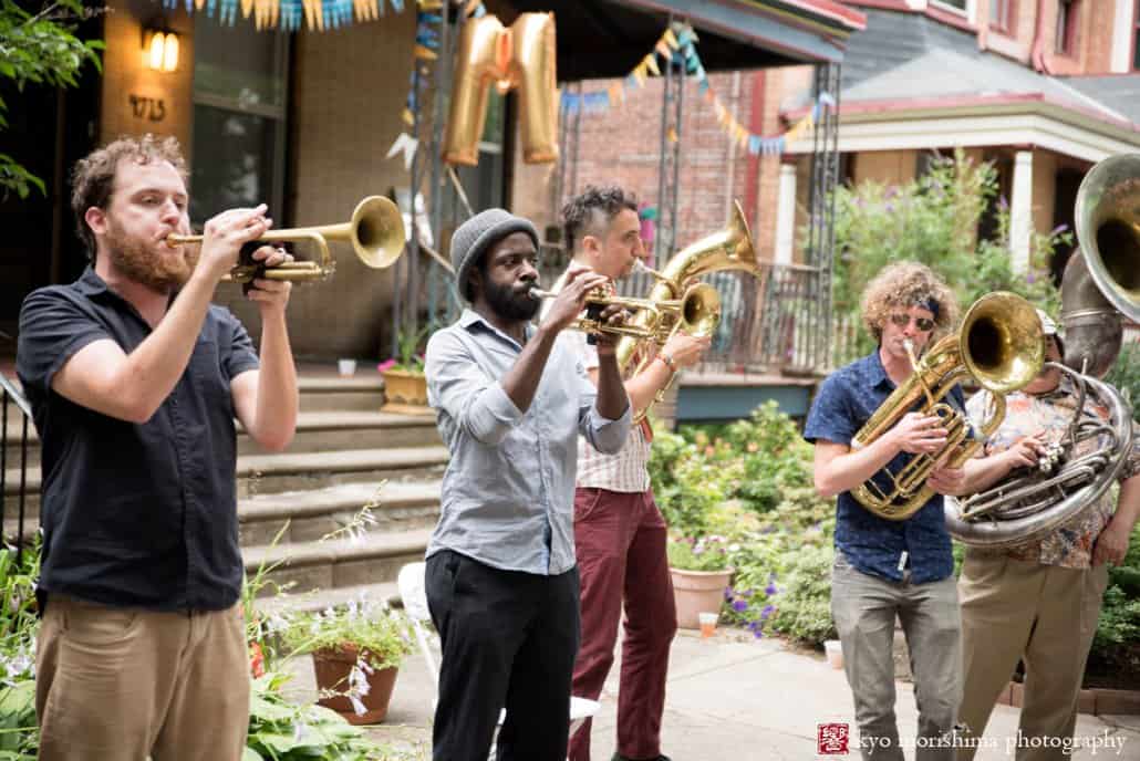 Koofreh Umoren plays the trumpet with his bandmates from West Philly Orchestra during block party wedding reception, photographed by Kyo Morishima
