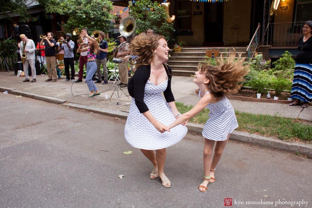 Teen and young girl dance joyfully during West Philadelphia block party wedding photographed by Kyo Morishima