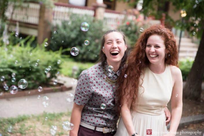 Portrait of the wedding couple with bubbles at West Philadelphia block party wedding photographed by Kyo Morishima