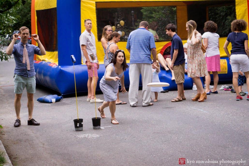 Wedding guest throws a frisbee during West Philadelphia block party wedding photographed by Kyo Morishima