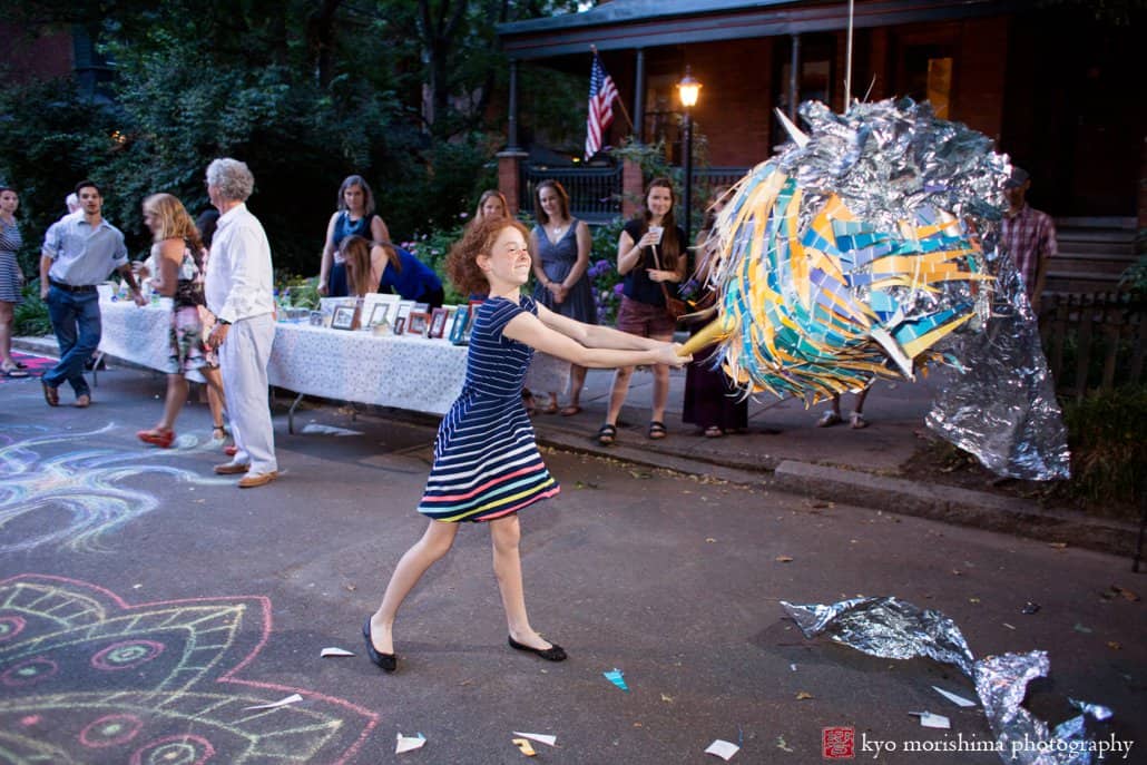 Young girl hits the pinata at West Philadelphia block party wedding photographed by Kyo Morishima