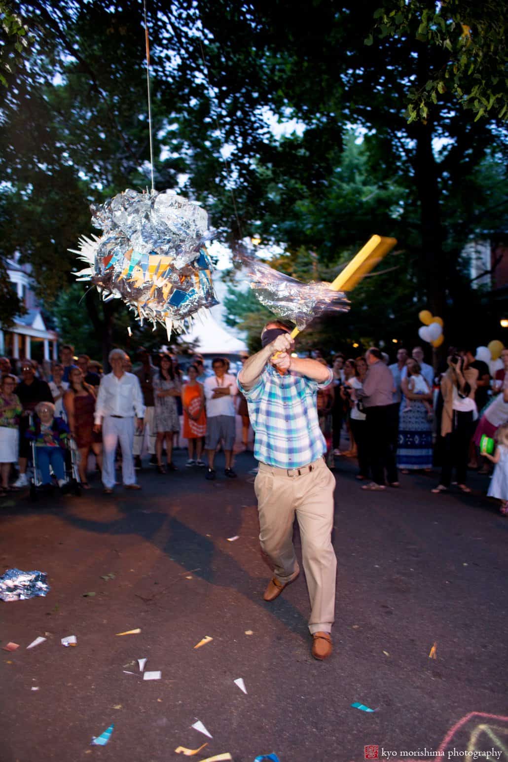 Man hits the pinata at West Philadelphia block party wedding photographed by Kyo Morishima