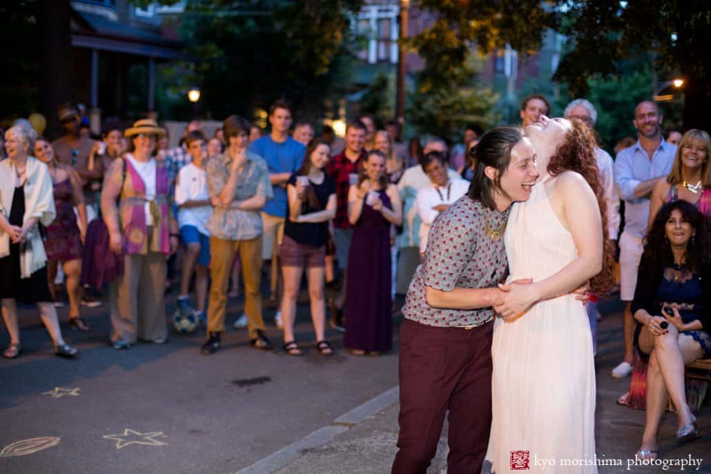 Wedding couple laughs during last toasts of the evening at West Philadelphia block party wedding photographed by Kyo Morishima