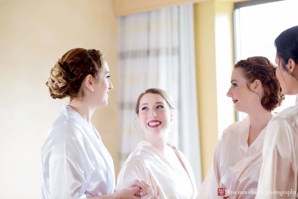 Bride laughing with bridesmaids while getting ready at Perona Farms, photographed by Kyo Morishima