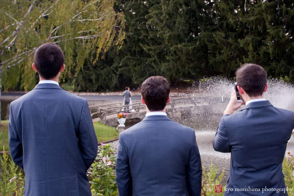 Groomsmen watch bride and groom's first look at Perona Farms, photographed by Sussex County wedding photographer Kyo Morishima