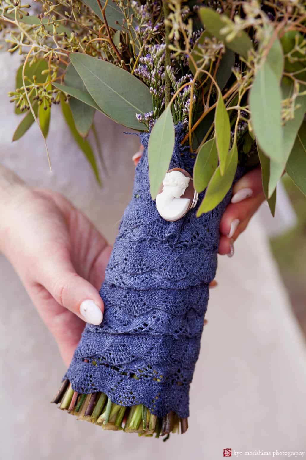 Detail of wedding bouquet stems wrapped in navy blue lace with cameo, photographed by Kyo Morishima