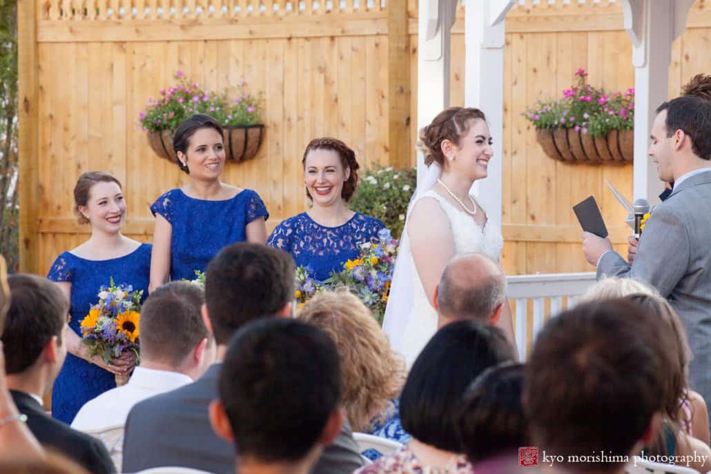 Laughter during outdoor courtyard wedding ceremony at Perona Farms, photographed by Kyo Morishima