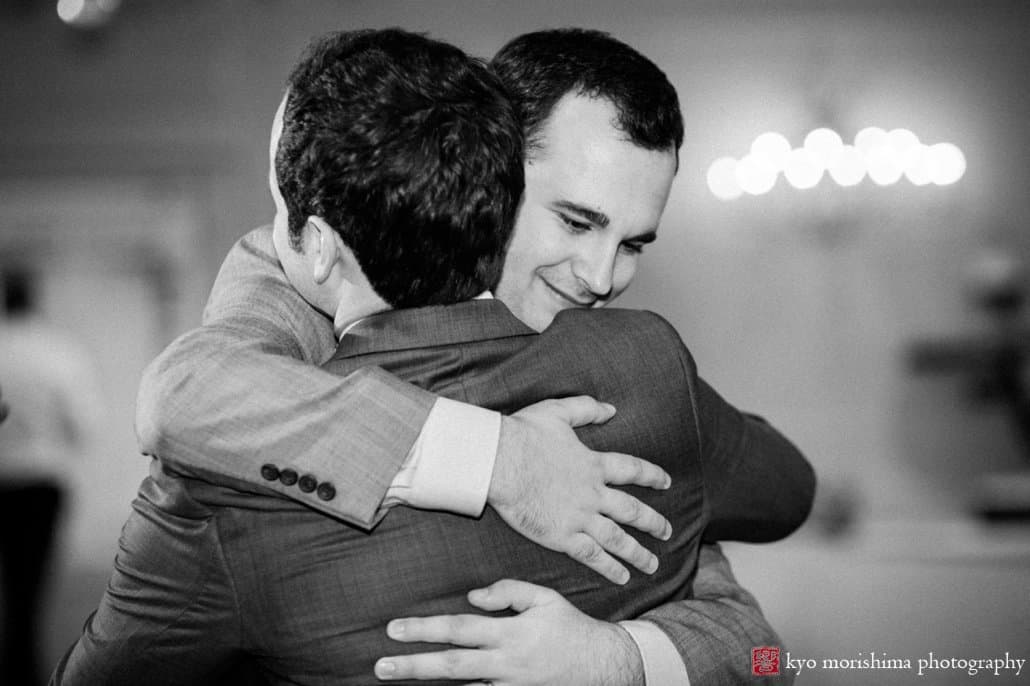 Groom and groomsmen embrace after toast at Perona Farms wedding photographed by Kyo Morishima