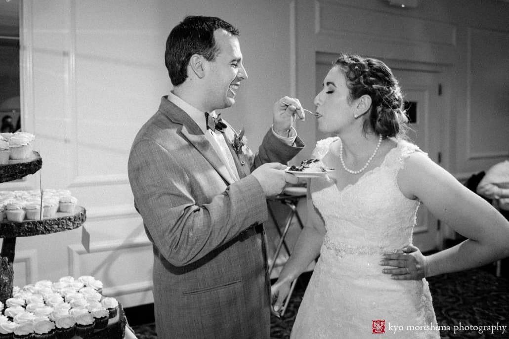 Groom gives bride a taste of wedding cake, photographed by Kyo Morishima
