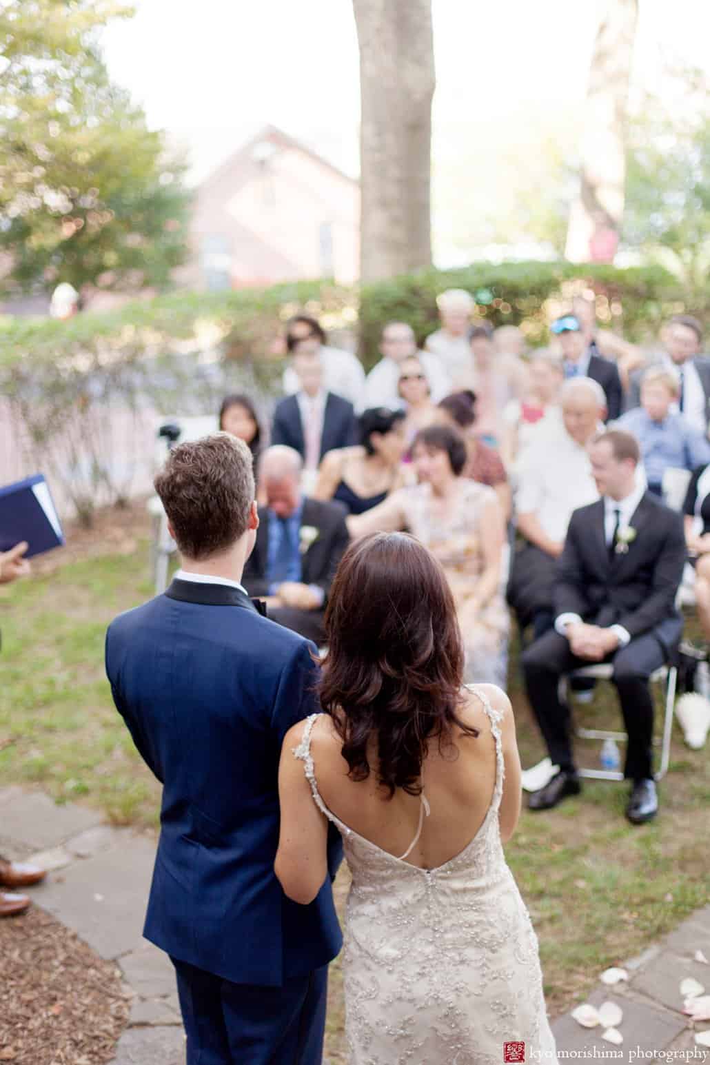 Bride and groom look out at guests as Governors Island wedding ceremony comes to an end, photographed by Kyo Morishima