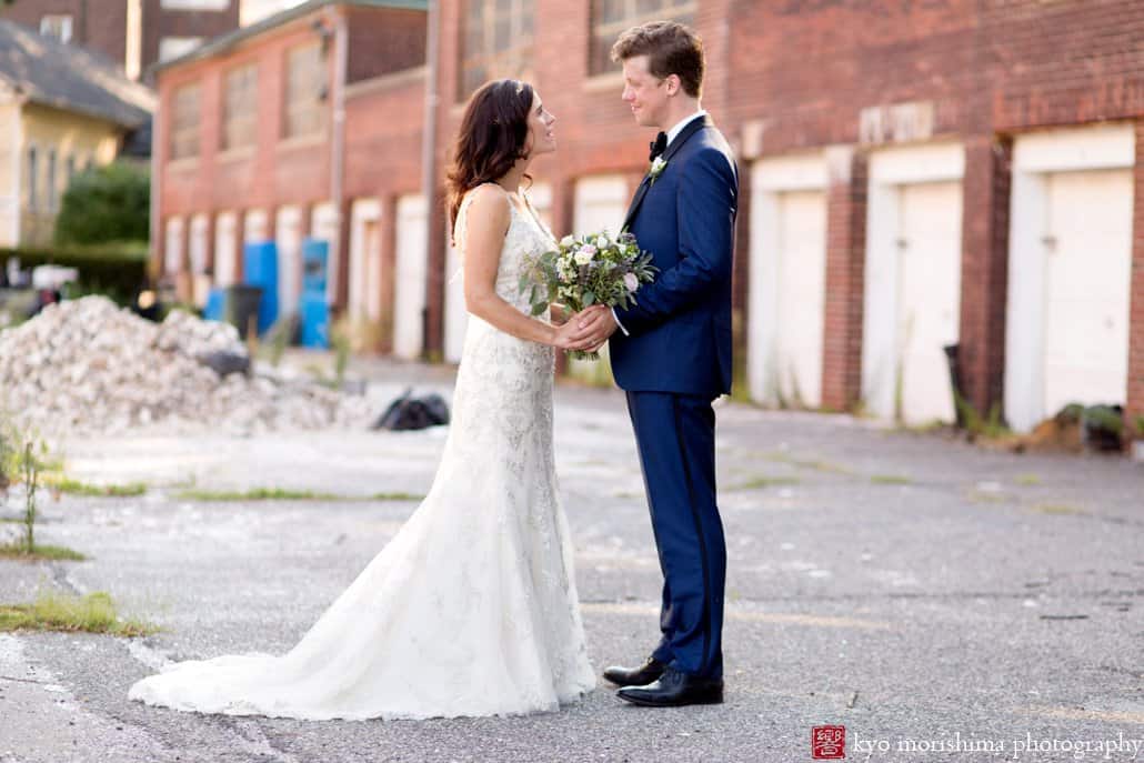 Bride and groom hold hands on a Governors Island alleyway, photographed by Kyo Morishima