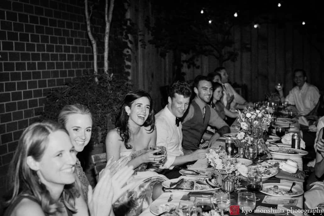 Bride and groom with guests at dinner on Frankies 457 Spuntino outdoor patio, photographed by Cobble Hill wedding photographer Kyo Morishima