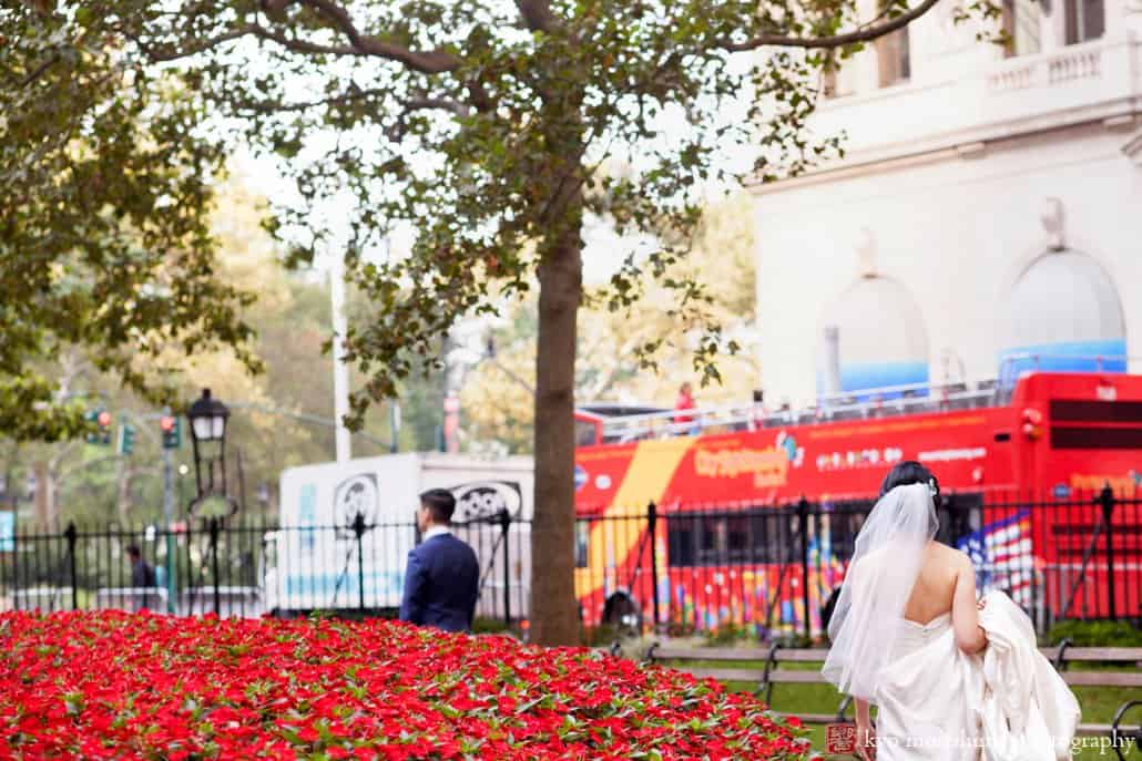 Bride approaches groom for first look in Bowling Green park, photographed by NYC wedding photographer Kyo Morishima