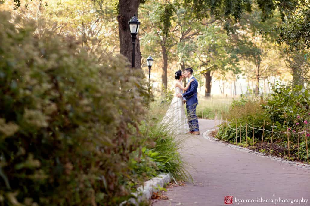 Bride and groom on a path in Bowling Green park in Wall Street, photographed by Kyo Morishima