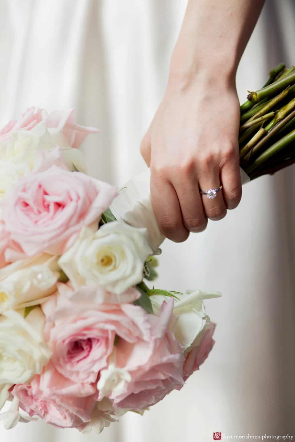 Bride holds pink and white rose wedding bouquet by Diva Flowers, photographed by NYC candid wedding photographer Kyo Morishima