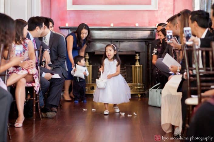 Flower girl heads down the aisle at India House wedding, photographed by Kyo Morishima