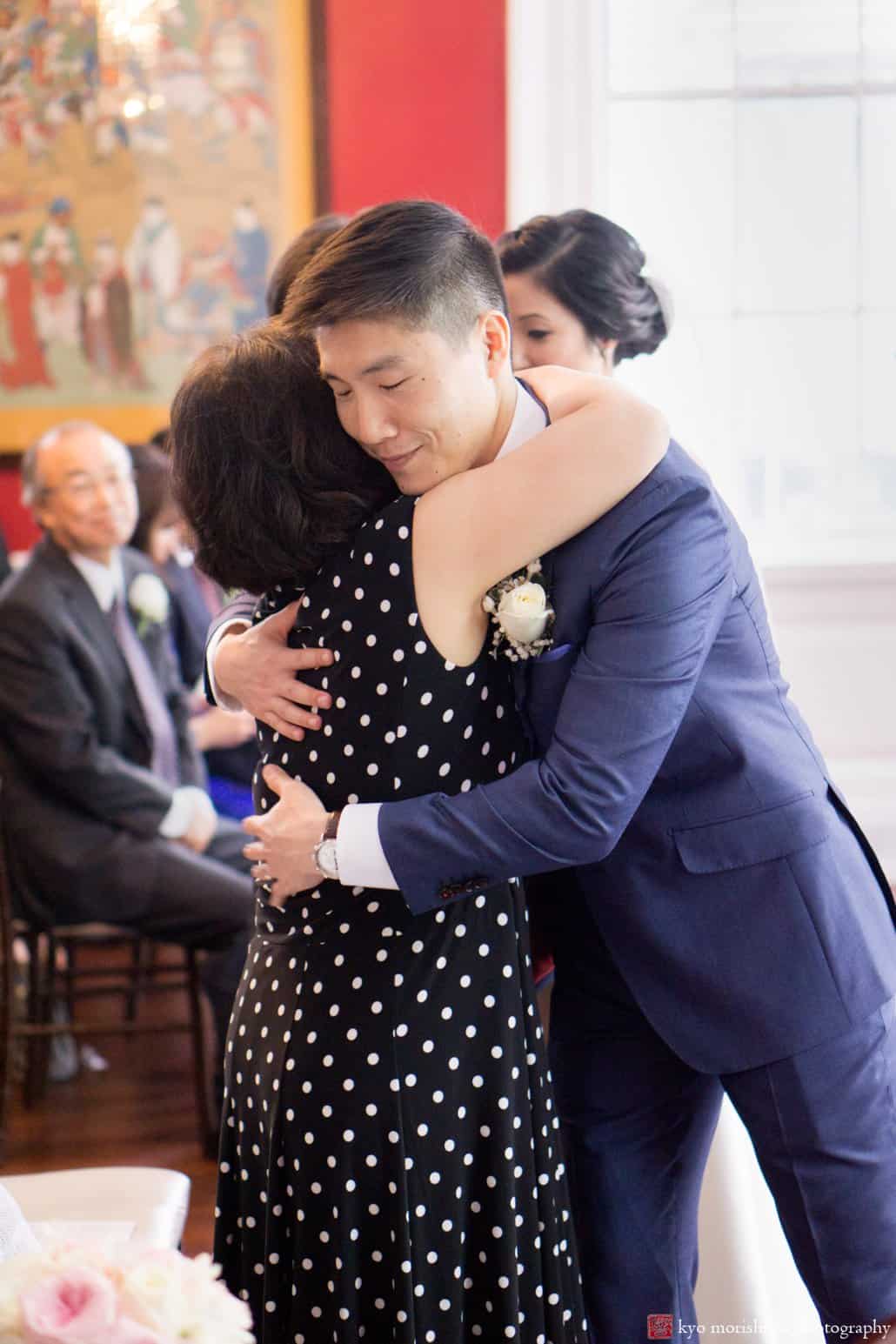 Groom hugs his mother during Korean wedding ceremony at India House, photographed by Kyo Morishima