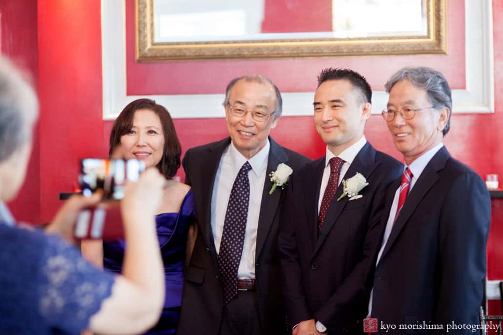 Guests pose for the camera during Korean wedding at India House, photographed by Kyo Morishima