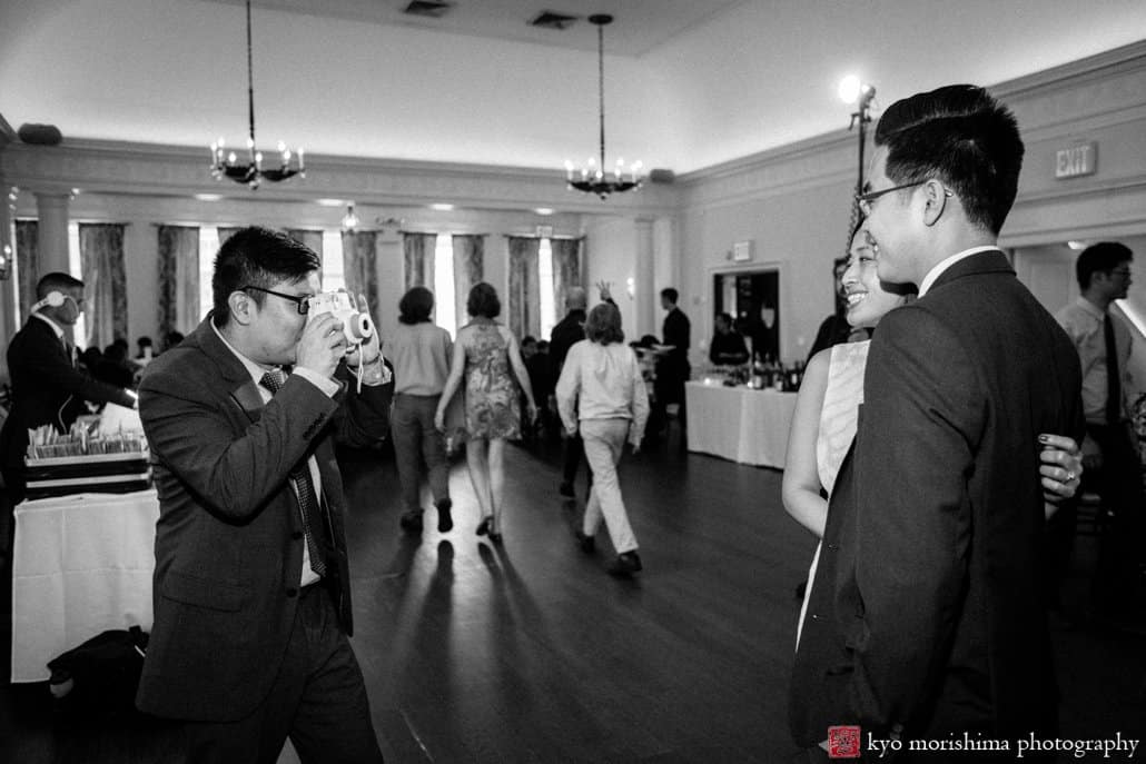 Guest snaps a Polaroid of another guest during Korean wedding at India House, photographed by Kyo Morishima