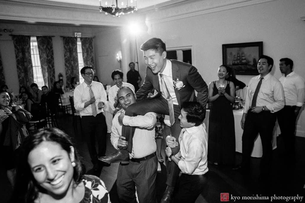 Groom is carried aloft by ebullient guests during Korean wedding at India House in Lower Manhattan, photographed by Kyo Morishima