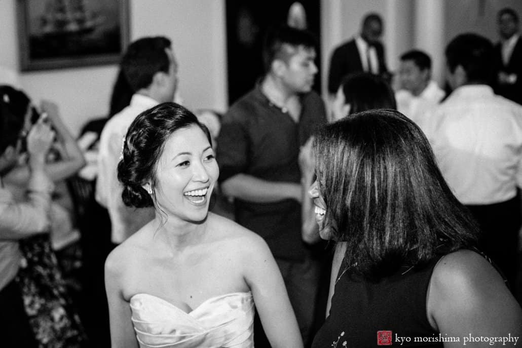 Bride laughs with guest at India House wedding, photographed by candid NYC wedding photographer Kyo Morishima