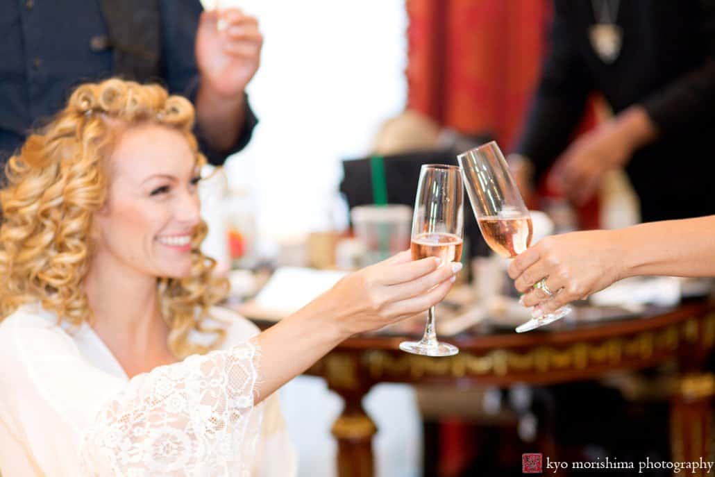 Bride and friends toast with champagne while getting ready at St. Regis Hotel, photographed by NYC documentary wedding photographer Kyo Morishima
