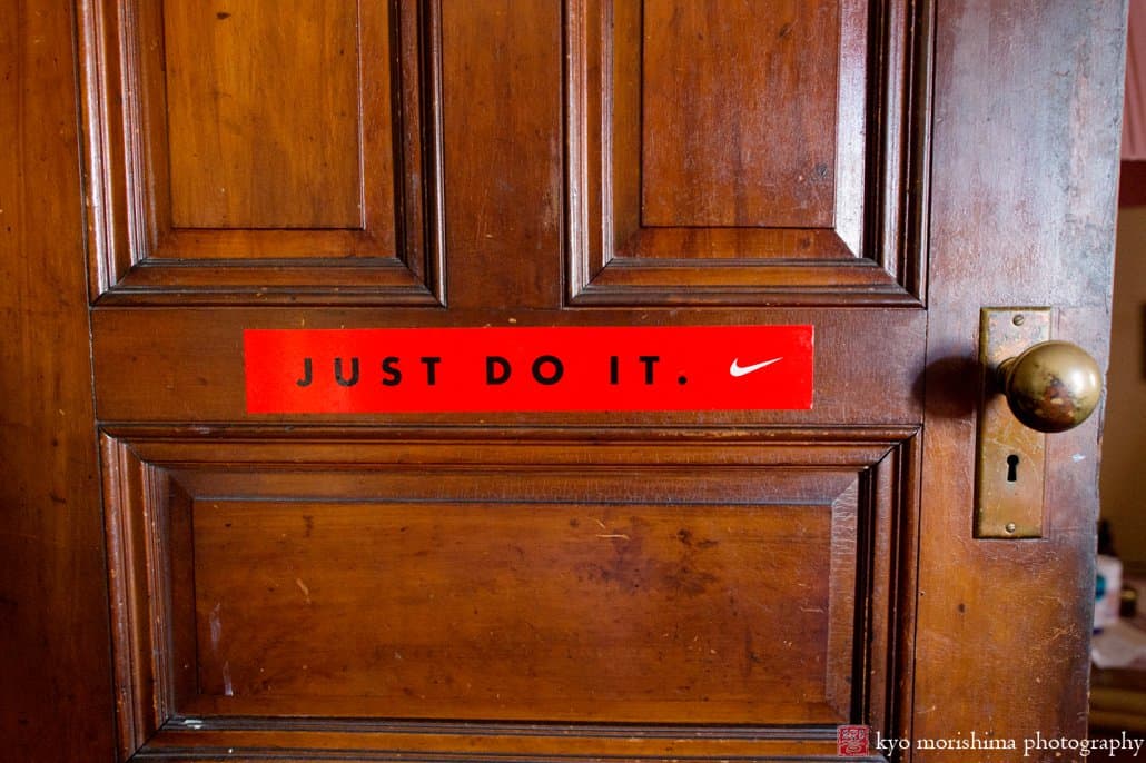 "Just Do It" bumper sticker on an old oak door in Harlem, photographed by Carlo Cipriani for Kyo Morishima Photography