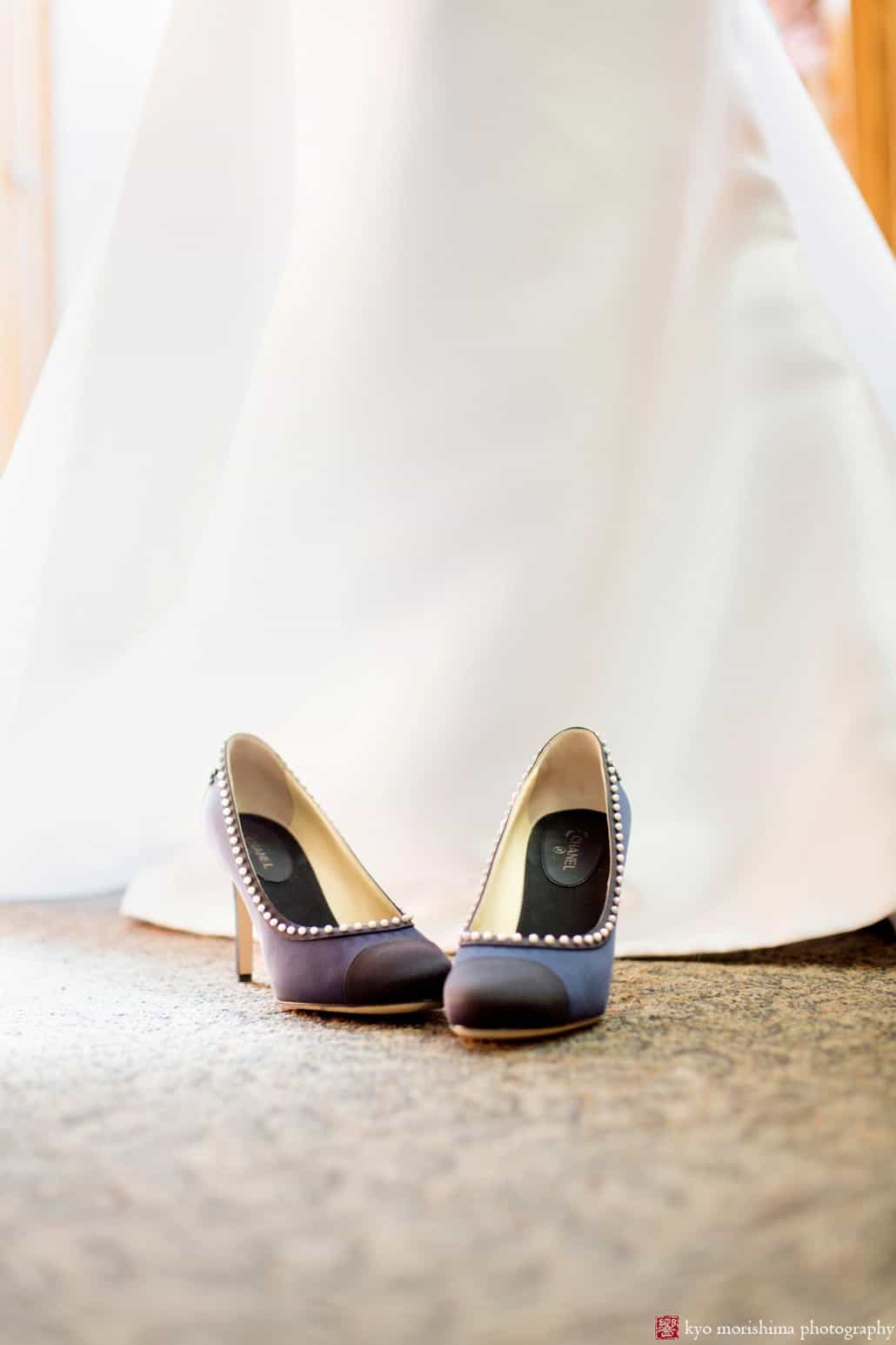 Navy blue Chanel heels with Pronovias wedding dress in the background, photographed by Kyo Morishima at St. John the Divine