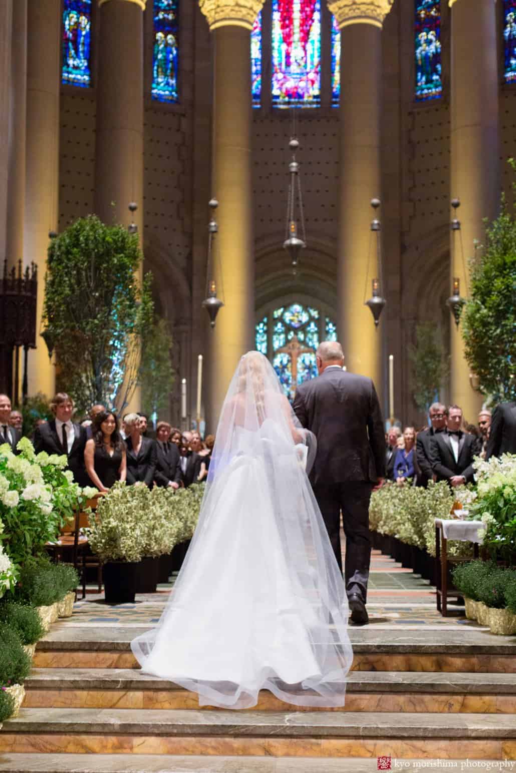 Bride and uncle walk down the aisle as St. John the Divine wedding begins, photographed by Kyo Morishima