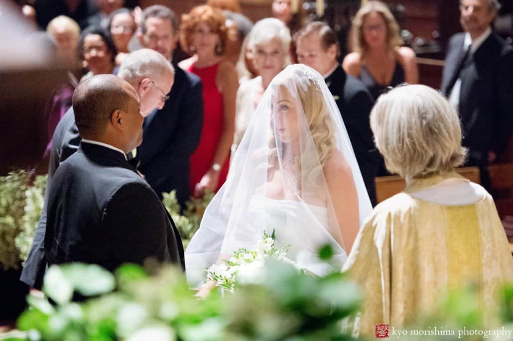 Bride smiles at groom as St. John the Divine wedding begins, photographed by Kyo Morishima