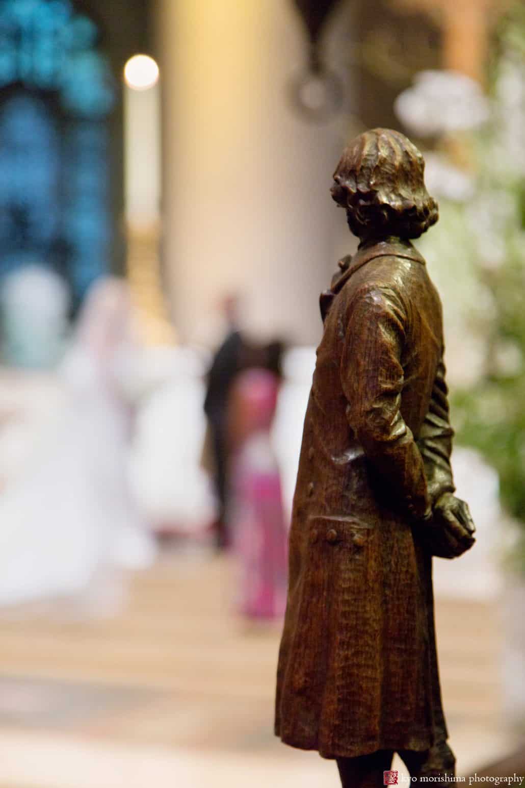Statue watches during St. John the Divine wedding ceremony 