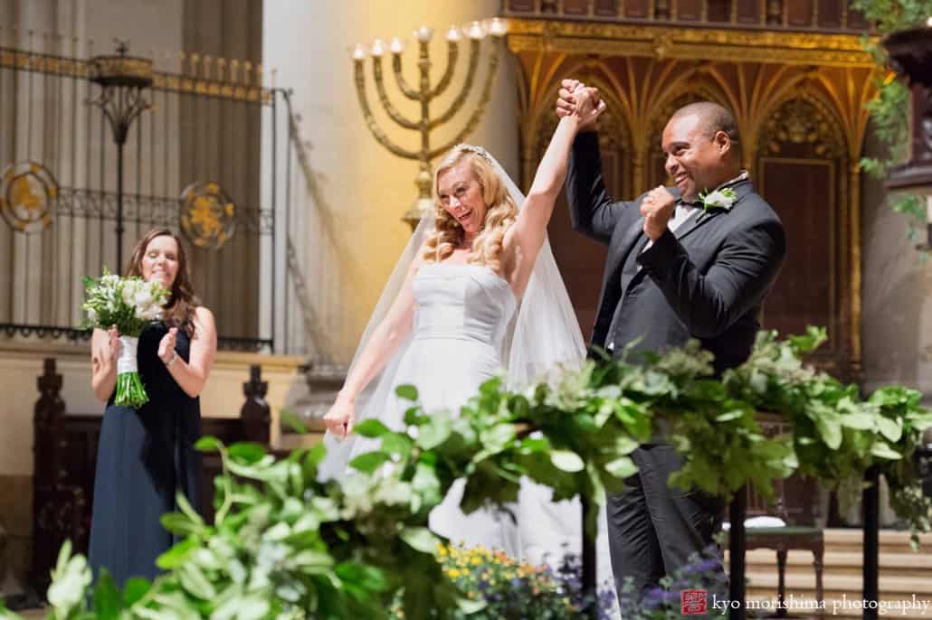 Bride and groom celebrate during St. John the Divine wedding ceremony