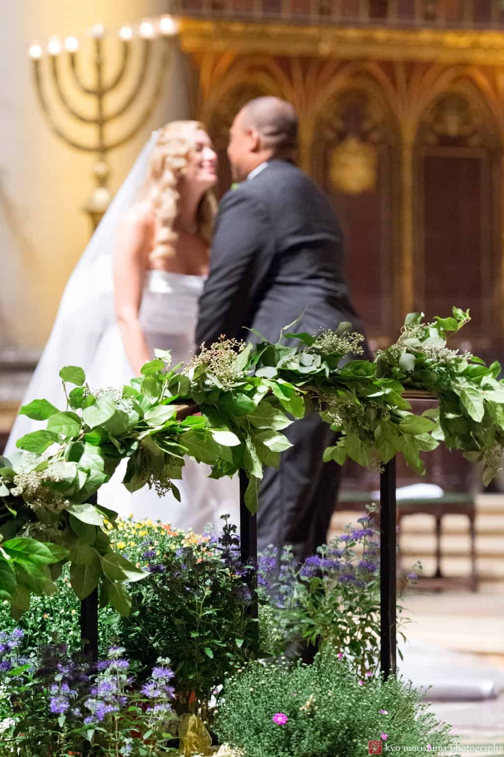 Bride and groom kiss during St. John the Divine wedding ceremony