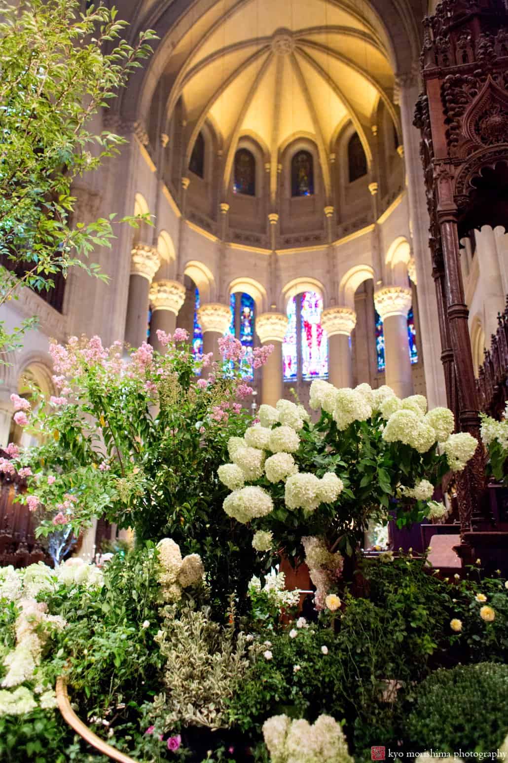 A view of the St. John the Divine chapel decorated with flowering shrubs for a wedding, photographed by Kyo Morishima