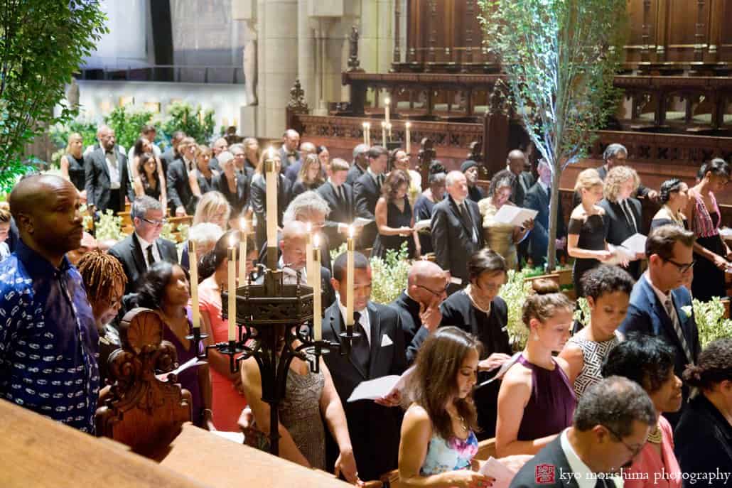 Guests participate in service during St. John the Divine wedding, photographed by Kyo Morishima
