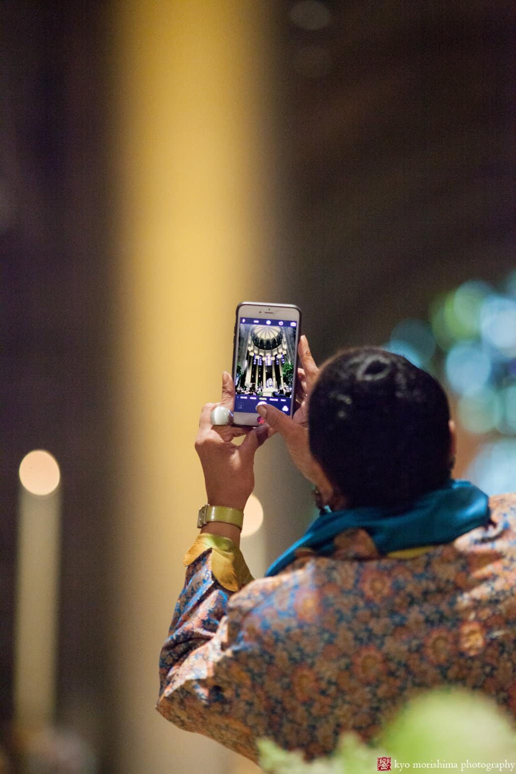 Guest snaps an iphone photo during St. John the Divine wedding, photographed by Kyo Morishima