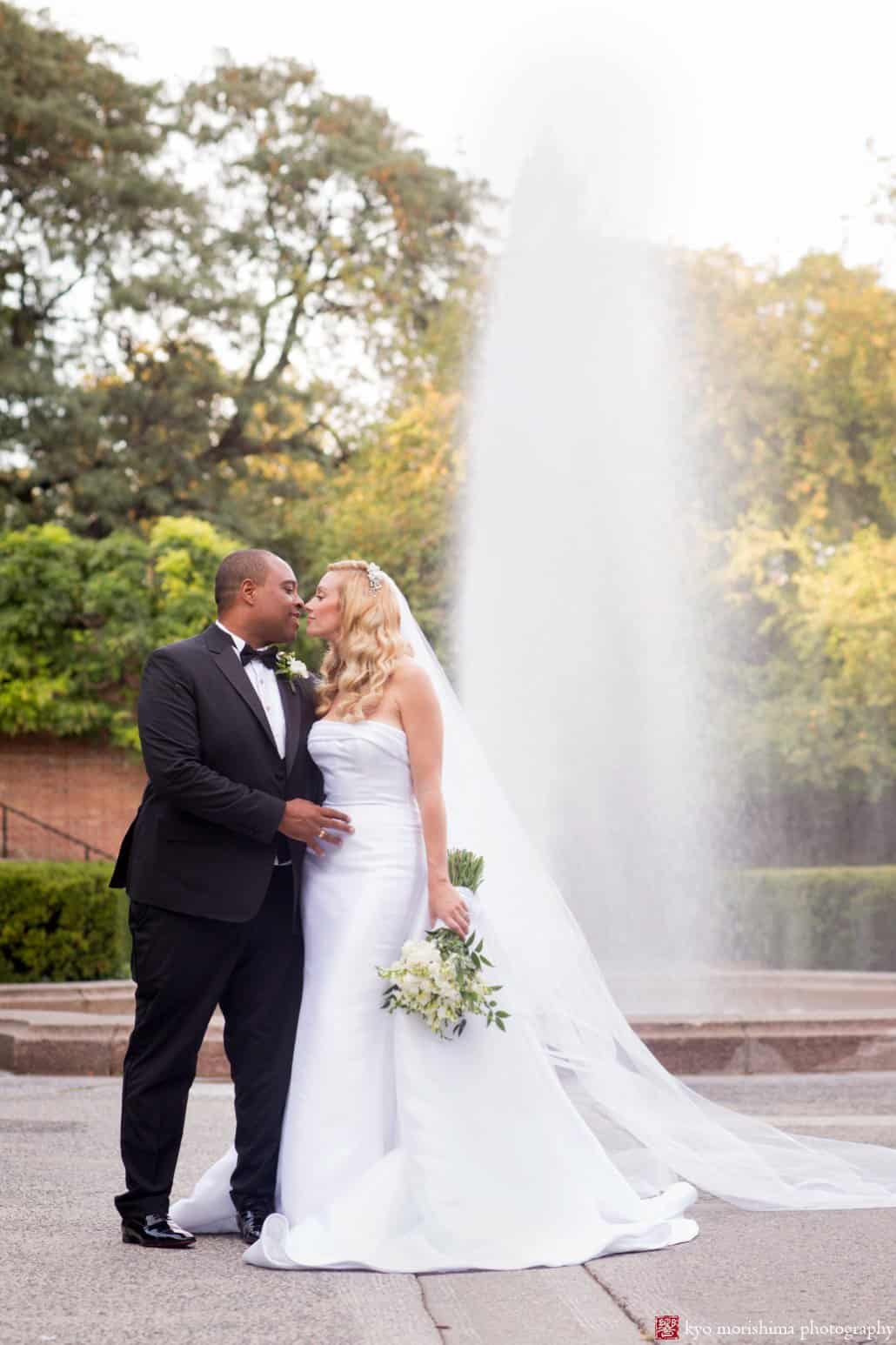 Bride and groom pose for Central Park Conservatory Garden wedding portrait
