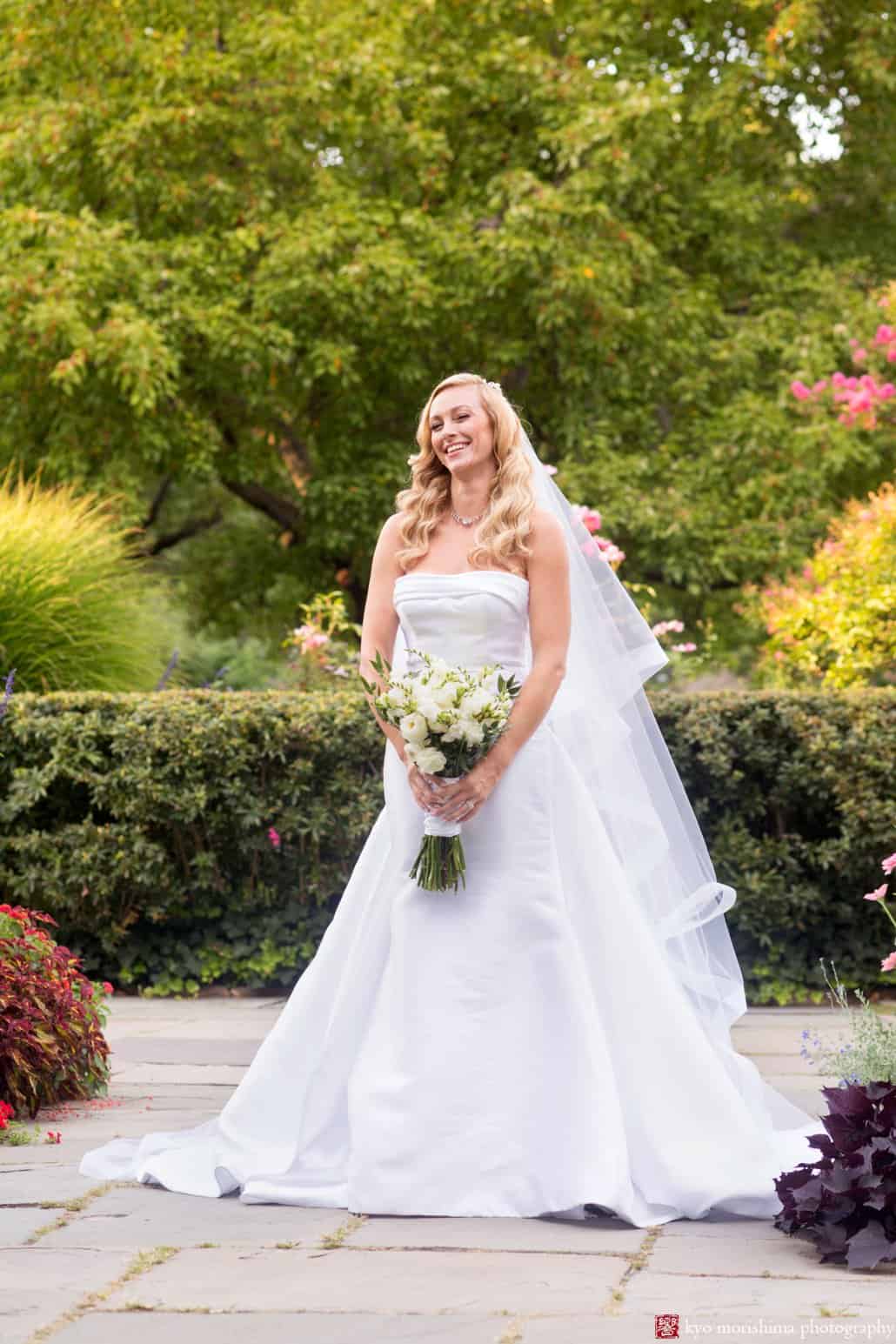 Bride laughs during Central Park Conservatory Garden portrait session