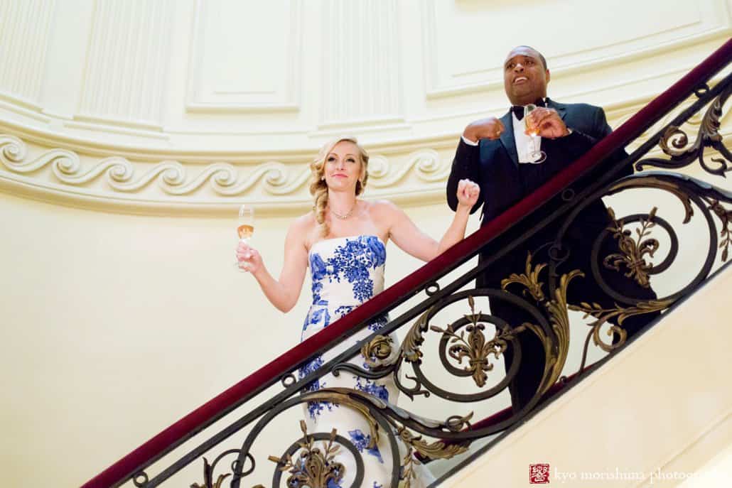 Bride and groom offer a toast from the staircase at Lotos Club wedding photographed by Kyo Morishima