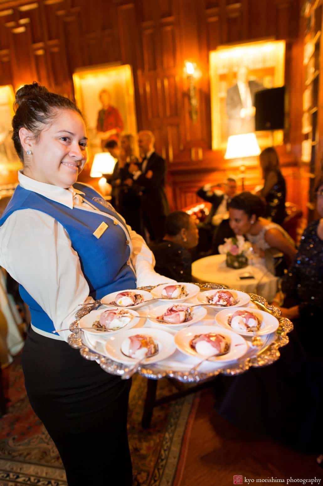 Waitress offers platter of food at Lotos Club wedding photographed by Kyo Morishima