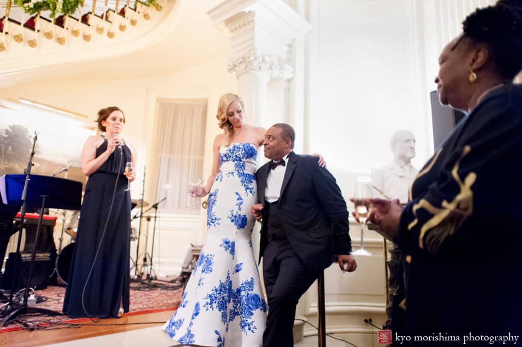 Bride and groom listen to a toast in the foyer at Lotos Club wedding reception, photographed by Kyo Morishima