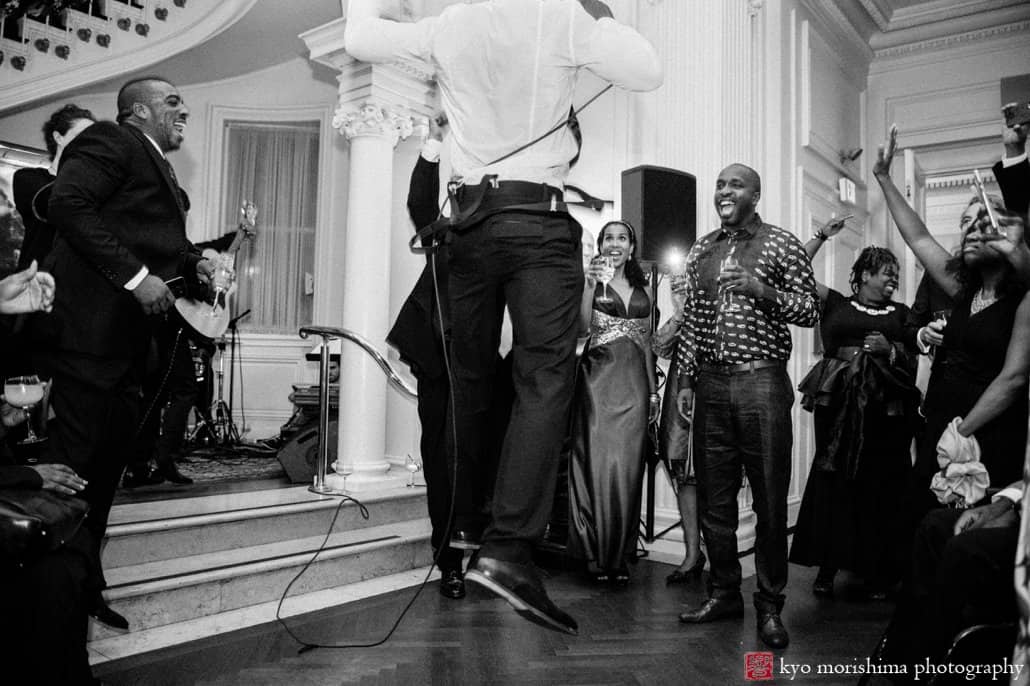 Musician jumps in the air during set at Lotos Club wedding reception photographed by Kyo Morishima